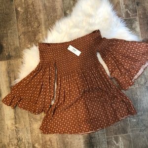 Strapless mini dress with long bell sleeves.